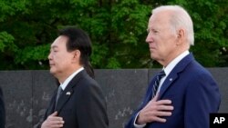 President Joe Biden and South Korea's President Yoon Suk Yeol pause after laying a wreath as they visit the Korean War Veterans Memorial in Washington, April 25, 2023.