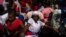 FILE - A Vodouist clad in white invokes a gede spirit during the Saint George celebration, in Port-au-Prince, Haiti, April 24, 2024. 