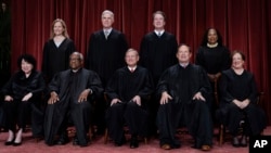 FILE - Supreme Court justices: bottom row, from left, Sonia Sotomayor, Clarence Thomas, Chief Justice John Roberts, Samuel Alito, and Elena Kagan; top row, from left, Amy Coney Barrett, Neil Gorsuch, Brett Kavanaugh, and Ketanji Brown Jackson, Oct. 7, 2022.