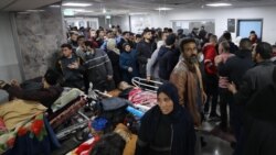 Injured people receive treatment in Gaza City's Al-Shifa hospital, following a reported Israeli strike, that according to Gaza's Health Ministry, killed at least 20 and wounded more than 150 as they waited for humanitarian aid, on Jan. 25, 2024.