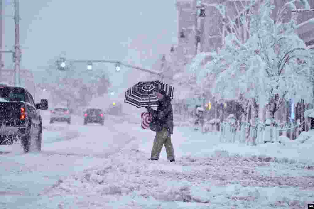 A man crosses a snow-covered street in Pittsfield, Massachusetts.&nbsp;The New England states and parts of New York are bracing for a winter storm due to last into Wednesday.&nbsp;