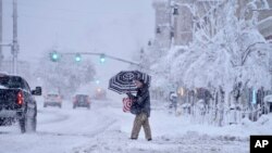 A man crosses a snow-covered street in Pittsfield, Massachusetts.&nbsp;The New England states and parts of New York are bracing for a winter storm due to last into Wednesday.&nbsp;