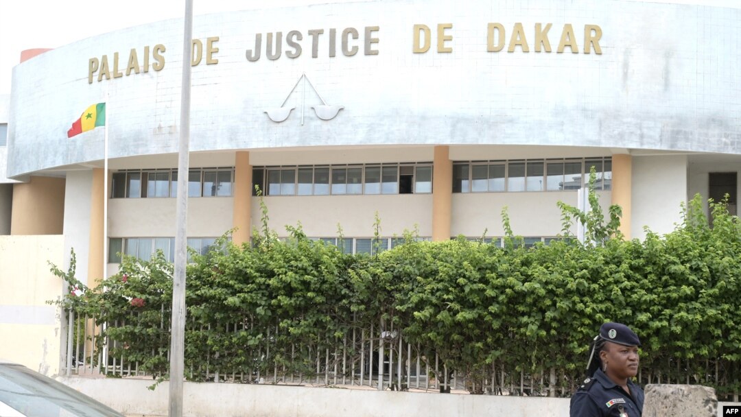 FILE - A Senegalese police officer is seen in front of a courthouse in Dakar on Sept. 21, 2022. 