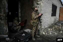 Ukrainian servicemen fly a drone to spot Russian positions near the city of Bakhmut, in the region of Donbas, March 5, 2023.