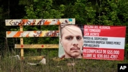 A posted wanted sign for a mass shooting suspect is shown, May 2, 2023, in the neighborhood where the shooting occurred Friday, in Cleveland, Texas. 