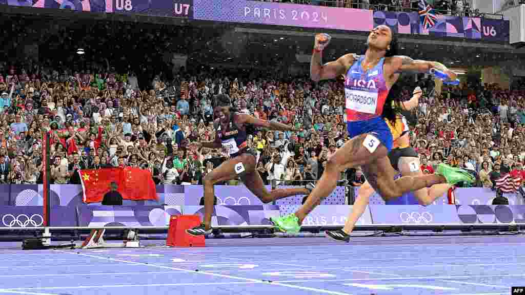 Sha'Carri Richardson of the U.S. crosses the finish line to win the women's 4x100 relay final at the Paris 2024 Olympic Games at Stade de France. 