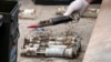 FILE - In this image provided by the U.S. Air National Guard, U.S. Air Force National Guard Explosive Ordnance Disposal Techinicians prepare several contaminated and compromised depleted uranium rounds, June 23, 2022, at Tooele Army Depot, Utah.