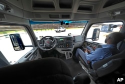The interior of the cab of a self driving truck is shown as the truck maneuvers around a test track in Pittsburgh, Thursday, March 14, 2024. (AP Photo/Gene J. Puskar)