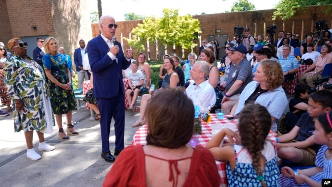 President Joe Biden speaks to supporters as first lady Jill Biden, second from left, listens, at a campaign rally in Harrisburg, Pennsylvania, July 7, 2024.