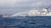In this handout photo provided by the Philippine Coast Guard, a Chinese coast guard ship uses water cannons on Philippine navy-operated supply boat M/L Kalayaan as it approaches Second Thomas Shoal in the disputed South China Sea on Dec. 10, 2023.