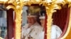 Britain's King Charles III and Britain's Queen Camilla travel in the Gold State Coach back to Buckingham Palace from Westminster Abbey in central London on May 6, 2023, after their coronations. 