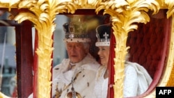 Britain's King Charles III and Britain's Queen Camilla travel in the Gold State Coach back to Buckingham Palace from Westminster Abbey in central London on May 6, 2023, after their coronations. 
