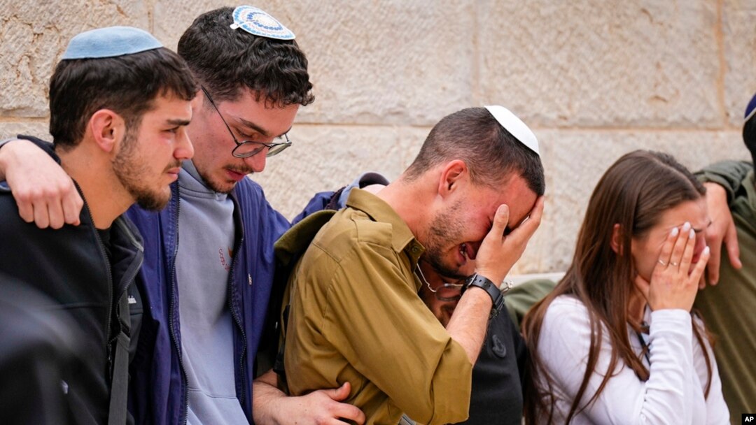 Friends of Israeli soldier Sergeant Lavi Ghasi mourn during his funeral in Modiin, Israel, Dec. 21, 2023. Ghasi, 19, was killed during the Israeli military's ground operation in the Gaza Strip.