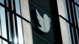 FILE - A Twitter logo hangs outside the company's offices in San Francisco, on Dec. 19, 2022. 