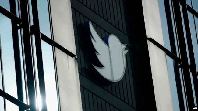 FILE - A Twitter logo hangs outside the company's offices in San Francisco, on Dec. 19, 2022.