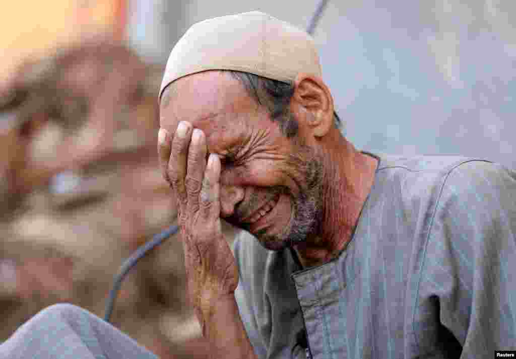 Hassan El Salheen weeps after burying the repatriated body of his son, Aly, who died along with his three cousins in Libya after Storm Daniel hit the country, at Al Sharief village in Bani Swief province, Egypt. REUTERS/Mohamed Abd El Ghany&nbsp;