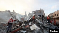 Палестинцы проводят операции по поиску и спасению на месте израильских авиаударов по жилому зданию в центральной части сектора Газа 31 октября 2023 года.