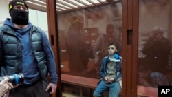 Dalerdzhon Mirzoyev, a suspect in the Crocus City Hall attack, sits in a glass cage at the Basmanny District Court in Moscow, Russia, March 24, 2024. The country's FSB security service said on April 1, 2024, that it arrested four more people it says are linked to the attack.
