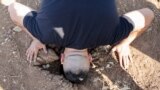 A man investigates the scene where three Palestinian gunmen were killed by an Israeli drone strike, near Jenin, in the Israeli-occupied West Bank.