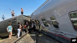 Para penumpang di lokasi tergelincirnya kereta di Kotelnikovo, 1.200 kilometer selatan Moskow, wilayah Volgograd, Rusia, Senin, 29 Juli 2024. Kereta tersebut sedang dalam perjalanan dari Kazan ke Adler,membawa 800 penumpang di dalamnya.(Administrasi Distrik Kotelnikovsky via AP)