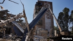 A Ukrainian emergency personnel works among the rubble of a destroyed hotel following a Russian strike, amid the Russian invasion of Ukraine, in the town of Kramatorsk, Ukraine, Aug. 25, 2024.