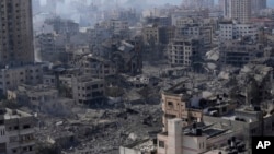 FILE - Destruction from Israeli aerial bombardment is seen in Gaza City, on Oct. 11, 2023.