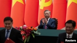 Vietnam's President To Lam applauds during a signing ceremony at the Great Hall of the People in Beijing, Aug. 19, 2024. 