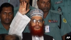 FILE - In this, Nov. 21, 2011, file photo, Bangladeshi police officers escort Delwar Hossain Sayeedi, a leader of Bangladesh's largest Islamic party Jamaat-e-Islami, as he leaves after an appearance before a special tribunal in Dhaka, Bangladesh.