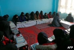 FILE - In this picture taken on February 13, 2023, Afghan girls learn the holy Koran at a madrassa or an Islamic school on the outskirts of Kabul. - Islamic schools have grown across Afghanistan since the Taliban returned to power in August 2021. (Photo by AFP)
