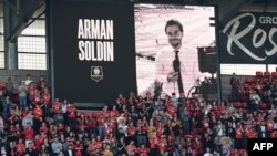 A portrait of slain AFP video reporter Arman Soldin is displayed on a giant screen before the French L1 football match between Stade Rennais FC and Troyes at a stadium in Rennes, western France, May 14, 2023. Soldin was a former youth player for the club.