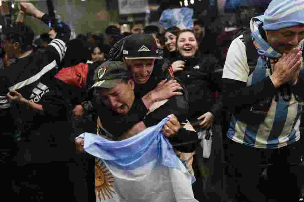 Argentina fans react during a broadcast in Buenos Aires after their team defeated Colombia at the Copa America final soccer match.