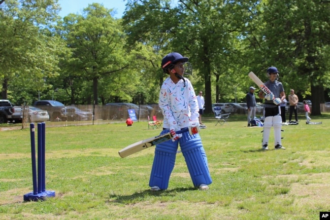 FILE - Akash Khargie, 8, left, learns proper bat holding and wicket position during a practice at Eisenhower Park in East Meadow, New York, May 11, 2024. (AP Photo/Phil Marcelo)