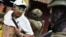 A soldier examines the back of a man, checking for gang tattoos, during a stop-and-frisk operation in Portoviejo, Ecuador, Jan. 11, 2024. 