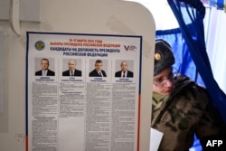 A service member votes in Russia's presidential election in Moscow on March 15, 2024.