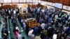 Ugandan lawmakers stand as they pass the Anti-Homosexuality Bill at a session inside the Parliament buildings in Kampala, Uganda, May 2, 2023. 