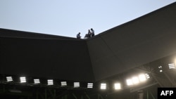 FILE - Security personnel watch from the roof during a rugby match at Geoffroy Guichard stadium in Saint-Etienne, France, Sept. 17, 2023. Security services arrested a man suspected of plotting an attack on a soccer game during the Olympic Games, an official said on May 31, 2024. 