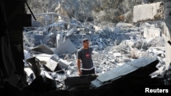 A Palestinian inspects a house destroyed in an Israeli strike, amid the Israel-Hamas conflict, in Nuseirat refuge camp, in the central Gaza Strip, July 9, 2024.