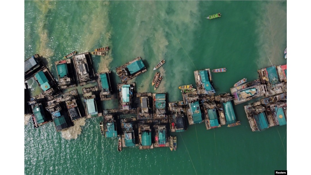 FILE - An aerial view shows wooden pontoons equipped to dredge the seabed for deposits of tin ore off the coast of Toboali, on the southern shores of the island of Bangka, Indonesia, May 1, 2021.