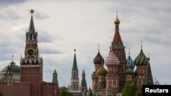 FILE - A general view on the Spasskaya tower of the Kremlin and St. Basil's Cathedral in Moscow, May 16, 2024. 