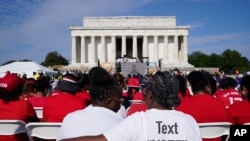 A crowd listens to speakers during an event to commemorate the 60th anniversary of the March on Washington for Jobs and Freedom at the Lincoln Memorial in Washington, Aug. 26, 2023.