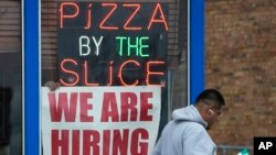 A hiring sign is displayed at a restaurant in Prospect Heights, Illinois, April 4, 2023.