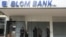 People stand outside a closed branch of Blom Bank in Sidon, Lebanon, Feb. 7, 2023. 