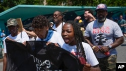 Legacy Garner, Eric Garner's youngest daughter, center, marches with family and supporters during an event to memorialize Eric Garner in the Staten Island borough of New York, July 17, 2024. 