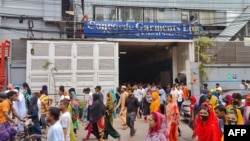 Garment workers break for lunch during work hours, in Dhaka on July 24, 2024. Garment factories and banks reopened in Bangladesh after authorities eased a curfew imposed to contain deadly clashes sparked by student protests. 