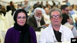In this photo taken on July 7, 2015, and provided by the Iranian Students' News Agency, ISNA, Iranian film director Dariush Mehrjui and his wife Vahideh Mohammadifar attend a film directors' meeting in Tehran, Iran.