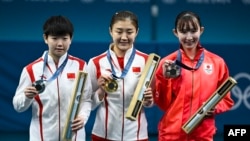 (From L) Silver medalist China's Sun Yingsha, Gold medalist China's Chen Meng and Bronze medalist Japan's Hina Hayata celebrate on the podium after the women's table tennis singles gold medal match at the Paris 2024 Olympic Games at the South Paris Arena in Paris, Aug. 3, 2024. 