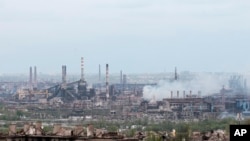 FILE - Smoke rises from the Metallurgical Combine Azovstal in Mariupol, in territory under the government of the Donetsk People's Republic, in Mariupol, Ukraine, May 5, 2022.