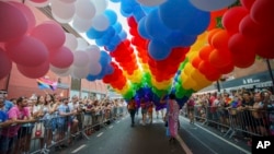 FILE - Revelers participate in the NYC Pride March, June 25, 2023, in New York.