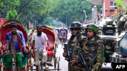 Bangladesh army stand guard near the country's Secretariat as the curfew is relaxed after the anti-quota protests, in Dhaka on July 27, 2024.