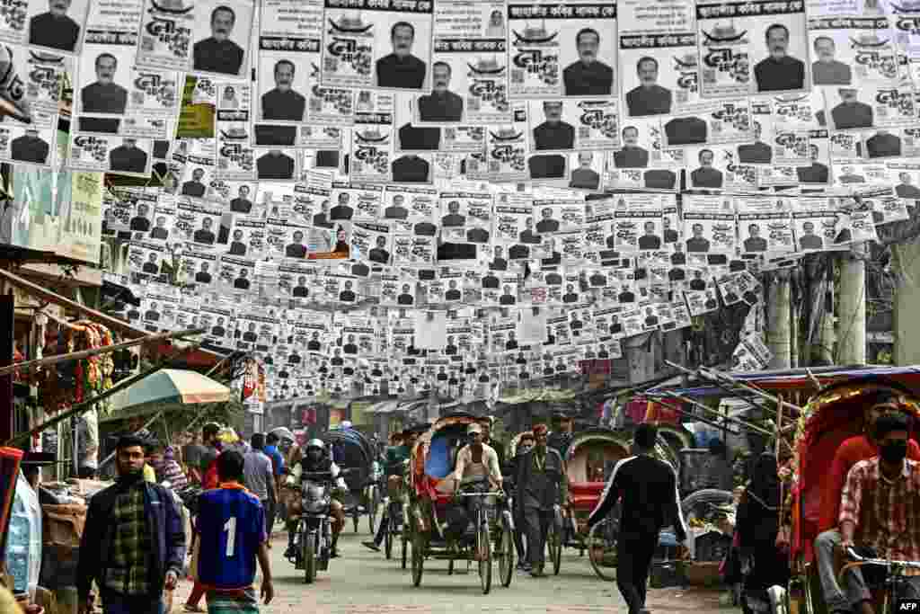 Posters of the election candidates hang over a street ahead of the 2024 general elections, in Dhaka, Bangladesh.